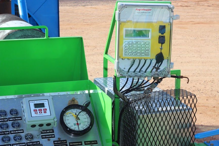 Rapidlogger recorder in its enclosure beside the control panel of an Acidizing Technology acid pump